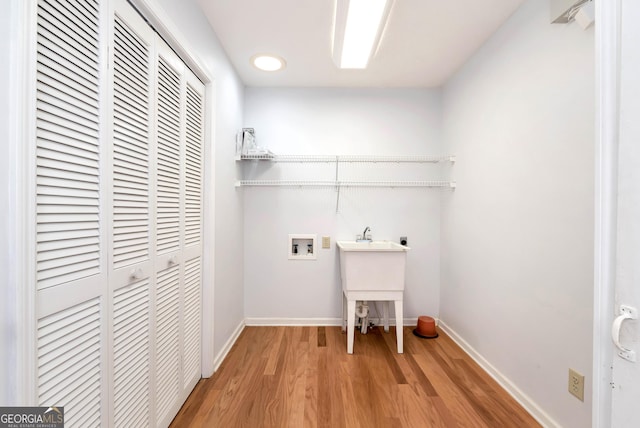 clothes washing area with electric dryer hookup, hardwood / wood-style floors, and hookup for a washing machine