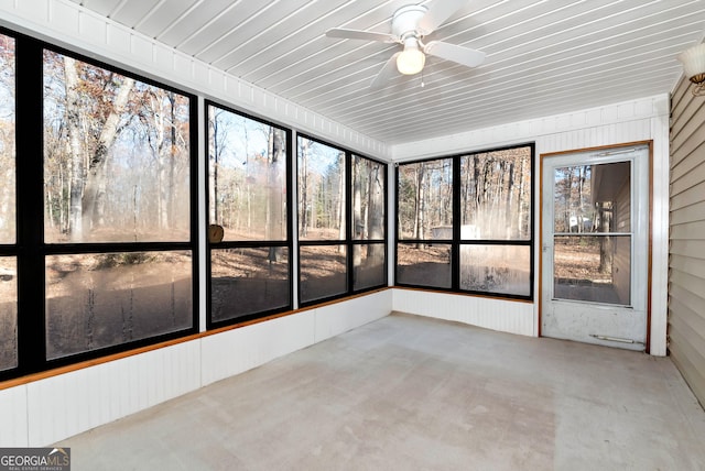 unfurnished sunroom featuring ceiling fan