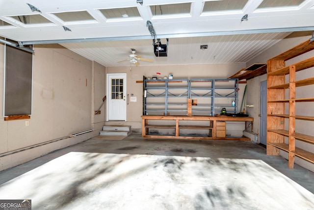 garage featuring ceiling fan, a workshop area, and a garage door opener