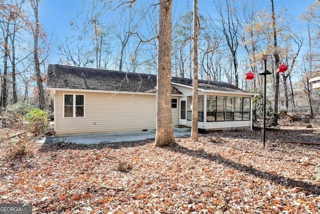 back of property featuring a sunroom and a patio