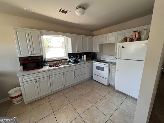 kitchen with white cabinetry, sink, white appliances, and light tile patterned floors