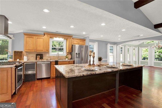 kitchen with dark wood-type flooring, lofted ceiling with beams, a kitchen island, backsplash, and appliances with stainless steel finishes