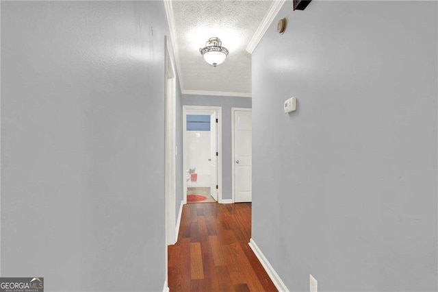 hallway featuring a textured ceiling, crown molding, and dark hardwood / wood-style floors