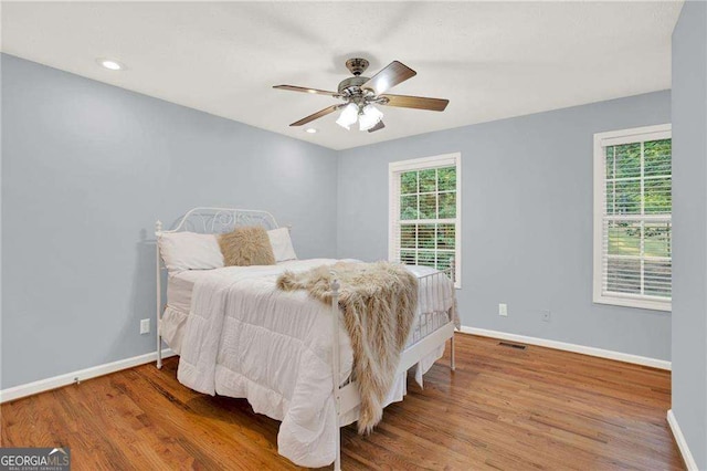 bedroom with ceiling fan and wood-type flooring