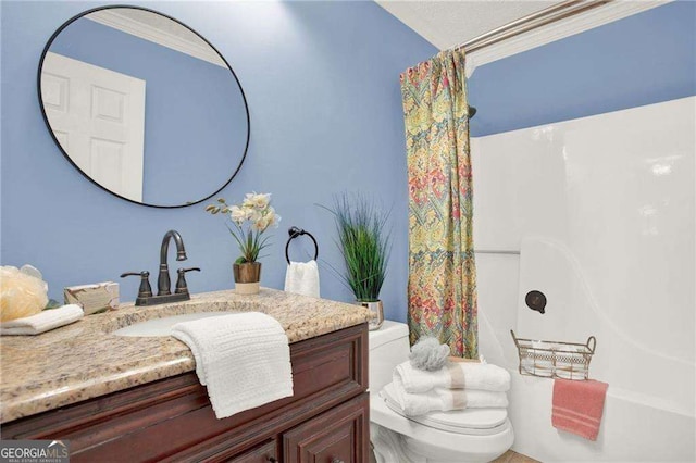 full bathroom featuring washtub / shower combination, crown molding, vanity, and toilet