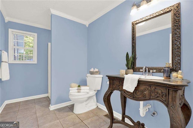 bathroom featuring toilet, vanity, crown molding, and tile patterned floors