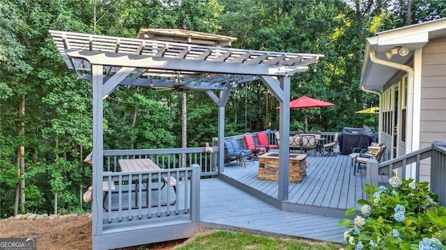 deck featuring an outdoor living space with a fire pit, a pergola, and grilling area