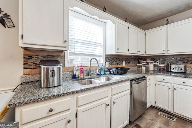 kitchen with sink, white cabinets, and dishwasher