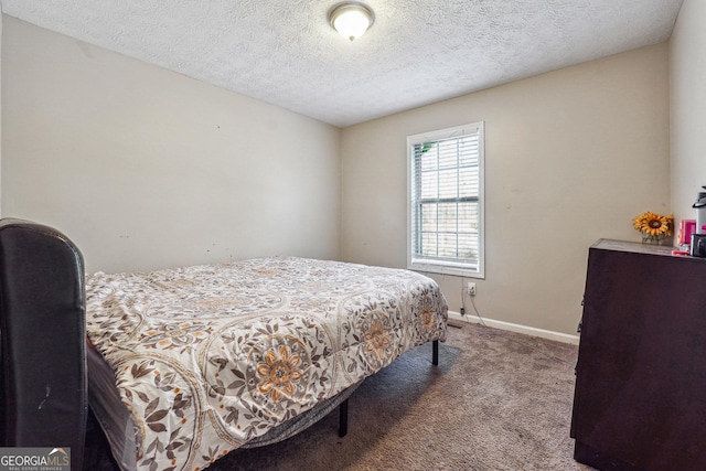 bedroom featuring a textured ceiling and carpet floors