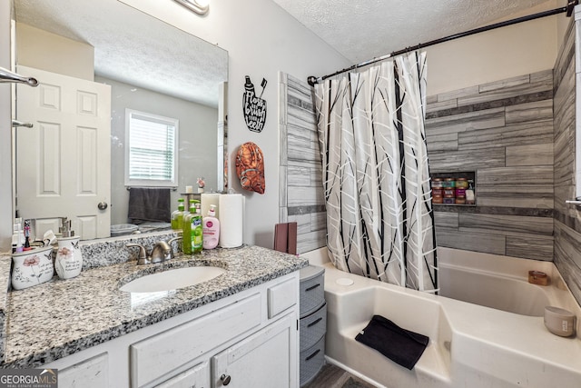 bathroom featuring shower / tub combo, vanity, and a textured ceiling