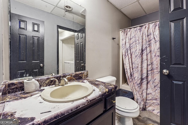 full bathroom featuring a paneled ceiling, shower / tub combo, vanity, and toilet