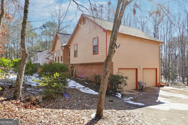 view of side of home with a garage