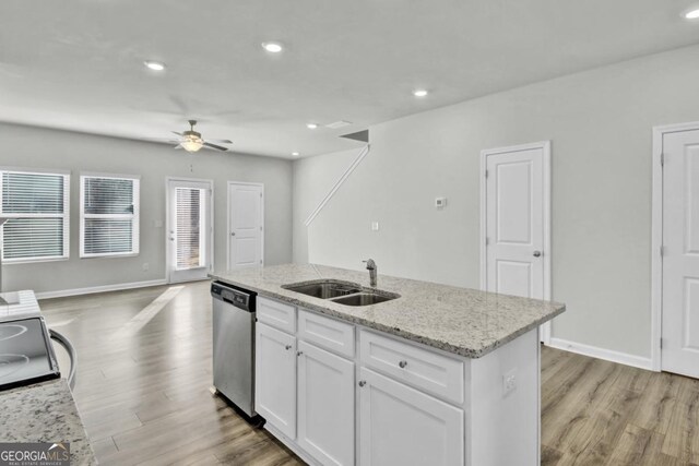kitchen with sink, white cabinets, ceiling fan, stainless steel dishwasher, and a kitchen island with sink