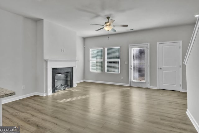 unfurnished living room featuring ceiling fan and light hardwood / wood-style flooring