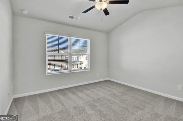 carpeted spare room with ceiling fan and lofted ceiling
