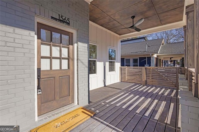 wooden terrace featuring ceiling fan