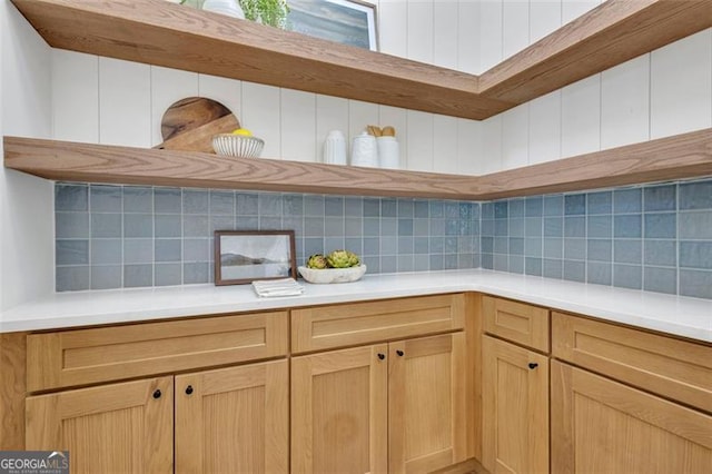 kitchen featuring light brown cabinetry and decorative backsplash