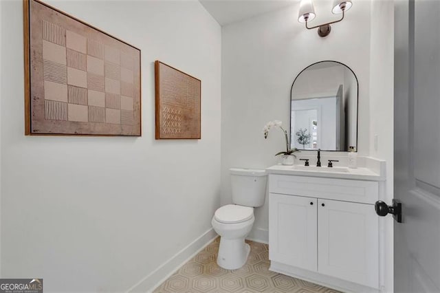 bathroom featuring toilet and vanity