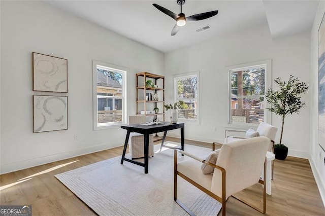 office area with ceiling fan and light hardwood / wood-style floors