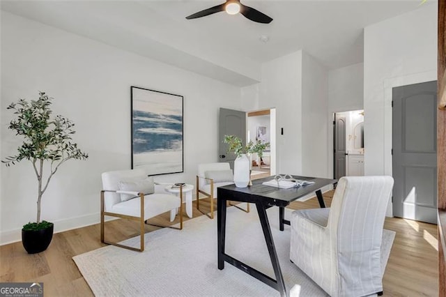 home office featuring ceiling fan and light hardwood / wood-style flooring