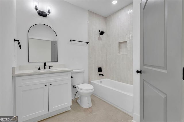 full bathroom featuring toilet, tiled shower / bath, tile patterned floors, and vanity