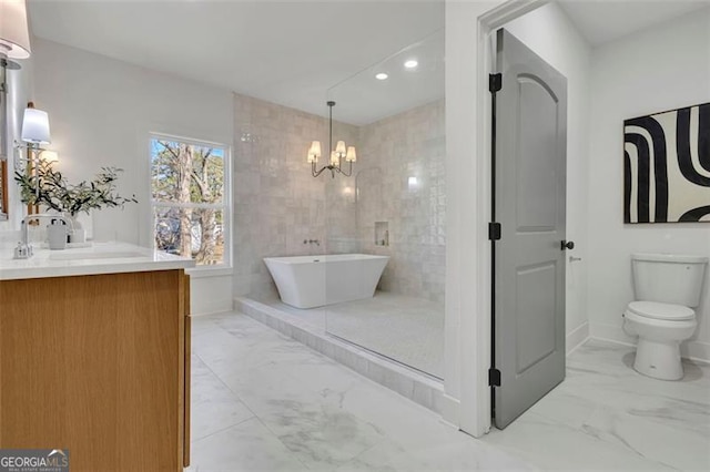 bathroom featuring tile walls, a tub, toilet, a notable chandelier, and vanity