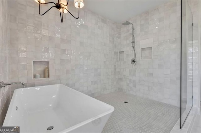 bathroom with tile walls and separate shower and tub