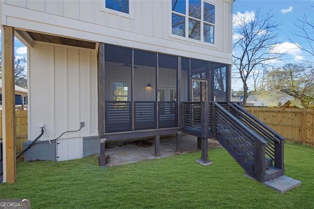 back of house featuring a yard and a sunroom