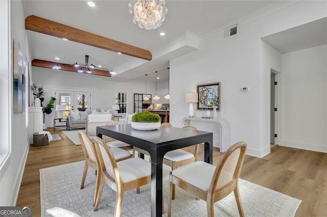 dining room with french doors, beamed ceiling, an inviting chandelier, and light hardwood / wood-style floors