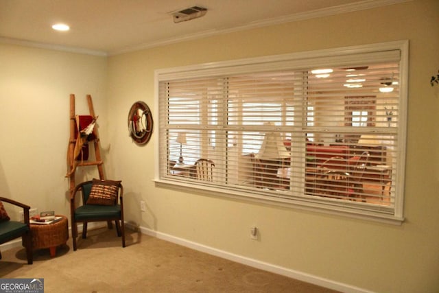 sitting room featuring carpet floors and ornamental molding