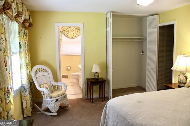 carpeted bedroom featuring ensuite bathroom and a closet