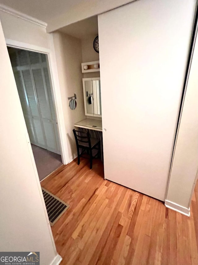 corridor with light hardwood / wood-style floors