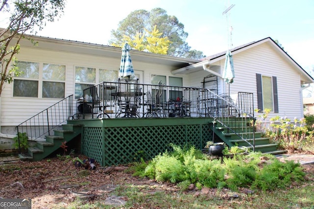 rear view of house featuring a deck