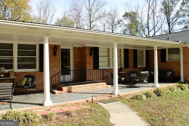 view of exterior entry with covered porch