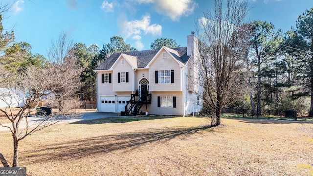 bi-level home featuring a front yard and a garage