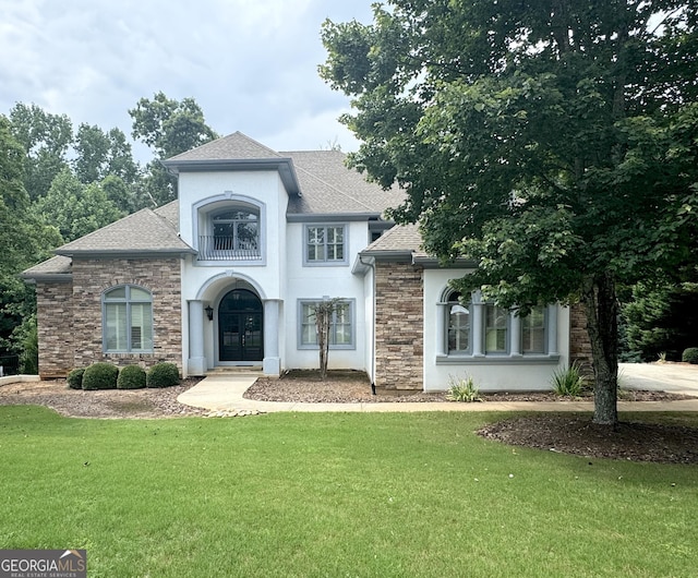 view of front of house with a front yard and french doors