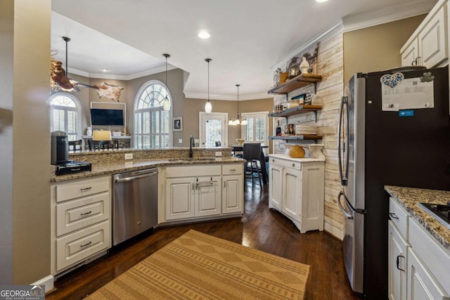 kitchen with stainless steel appliances, sink, white cabinets, ornamental molding, and kitchen peninsula