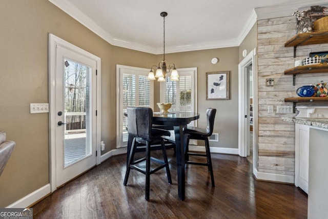 dining space featuring a notable chandelier, crown molding, and dark hardwood / wood-style flooring