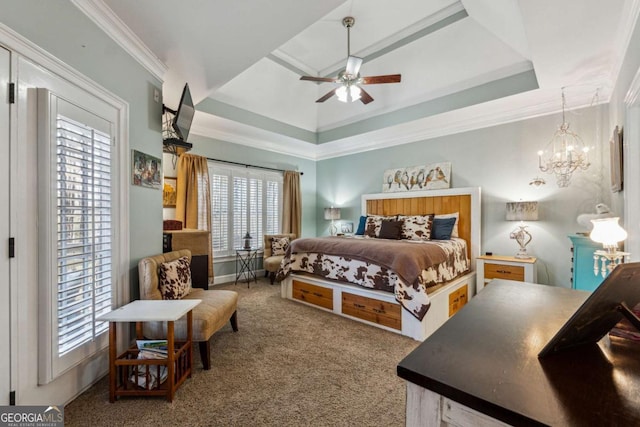 bedroom featuring ceiling fan with notable chandelier, a raised ceiling, crown molding, and carpet flooring