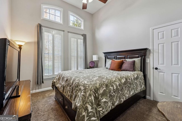 bedroom featuring ceiling fan, high vaulted ceiling, and dark carpet