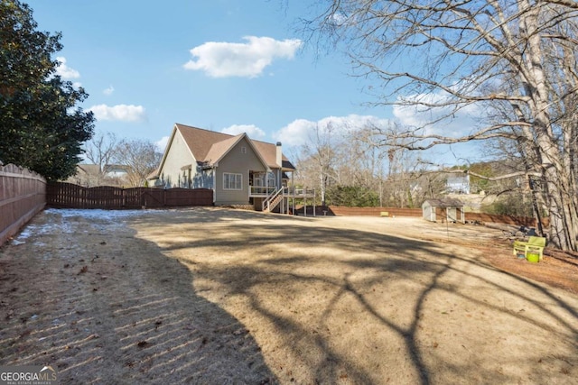 rear view of house with a storage shed