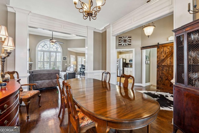 dining space featuring ornamental molding, dark hardwood / wood-style flooring, a barn door, and ceiling fan with notable chandelier