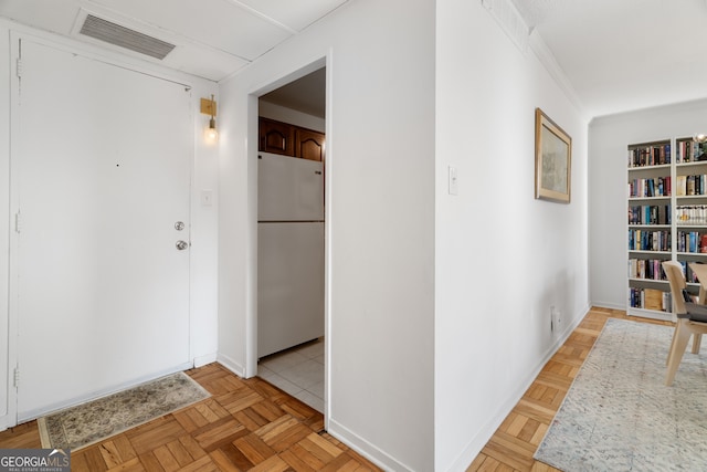 hall featuring light parquet flooring and ornamental molding