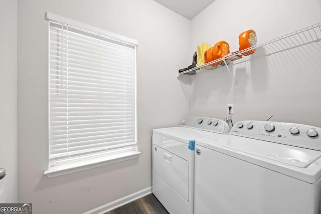 washroom featuring washing machine and dryer and dark hardwood / wood-style floors