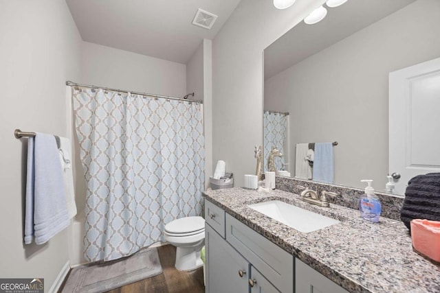 bathroom featuring toilet, hardwood / wood-style flooring, and vanity