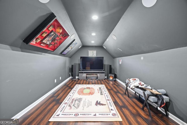 cinema featuring vaulted ceiling and dark hardwood / wood-style floors