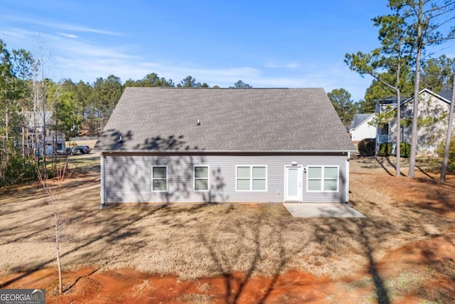 back of house with a yard and a patio