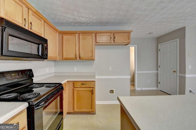 kitchen with black appliances and light brown cabinetry