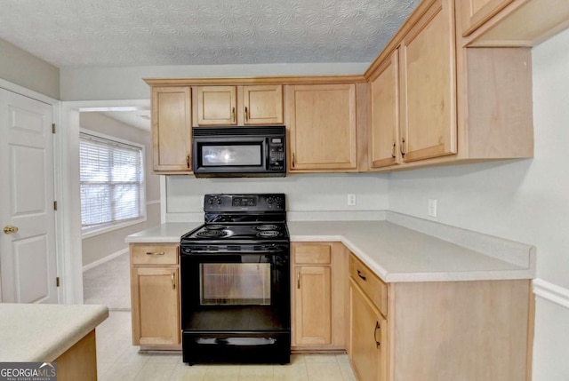 kitchen featuring light brown cabinetry, black appliances, and a textured ceiling