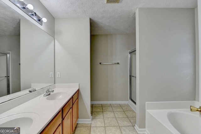 bathroom featuring a textured ceiling, shower with separate bathtub, and vanity